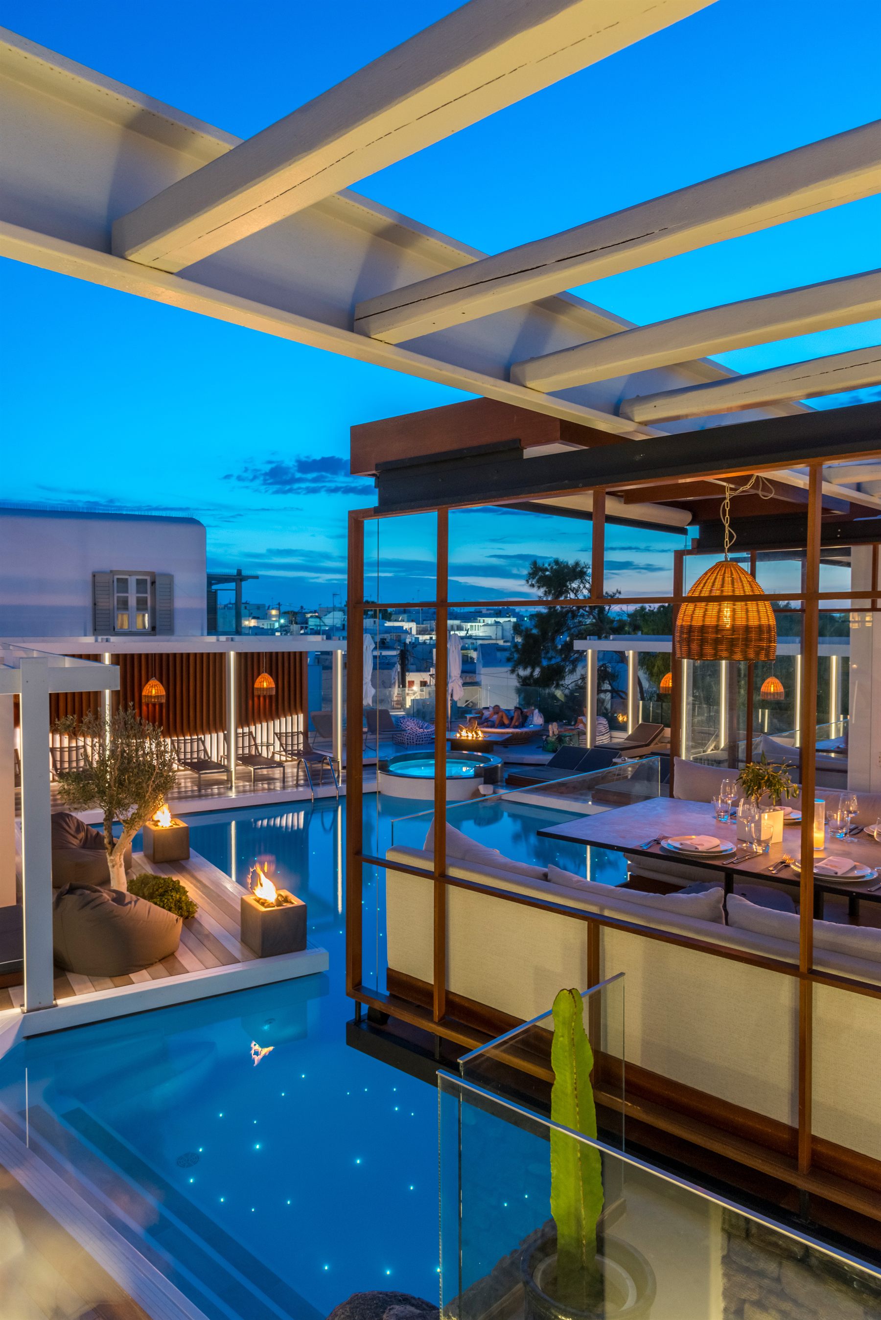 Krama pool and glass dining room at dusk