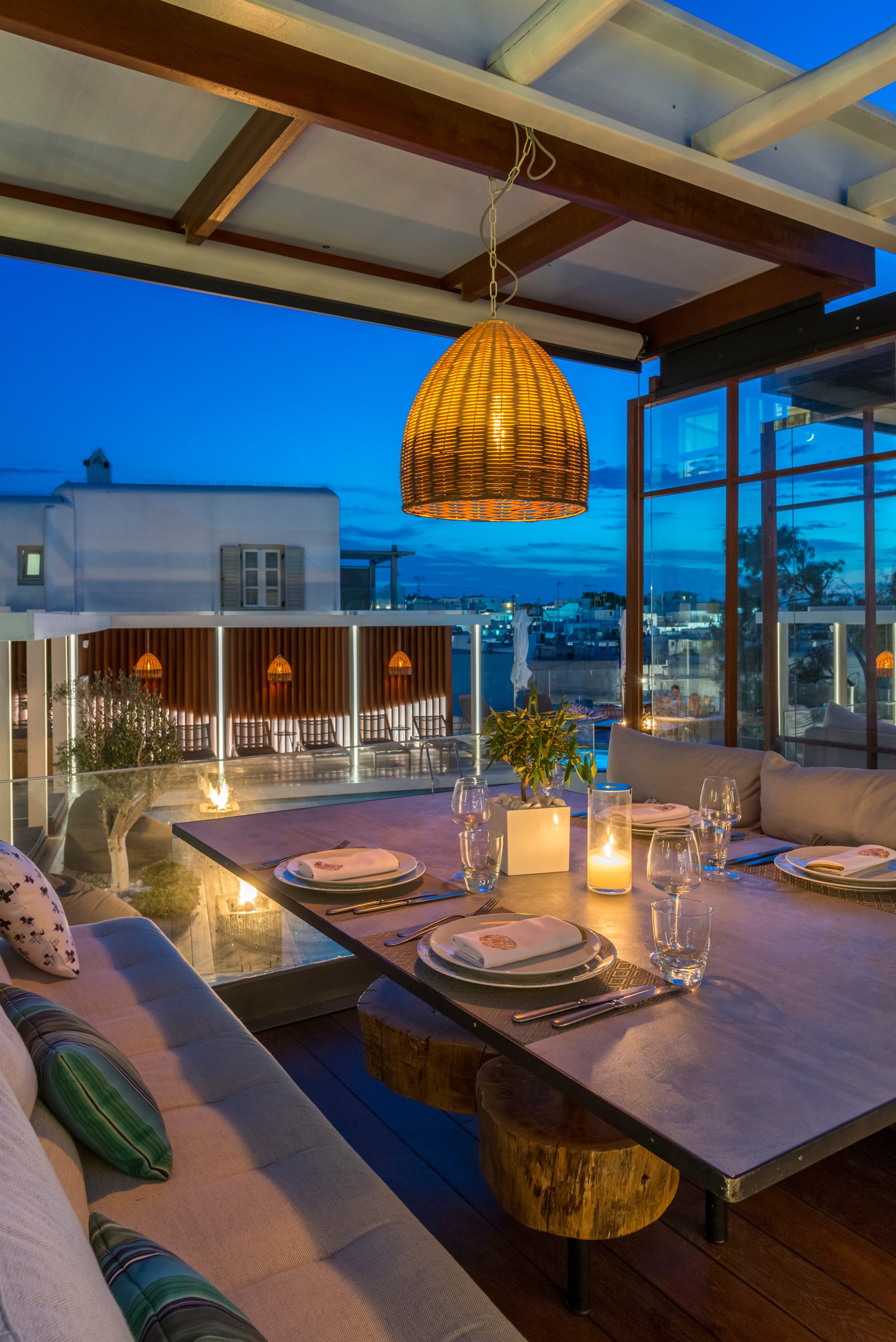 A candle-lit table set for a celebration on Krama's rooftop, Mykonos